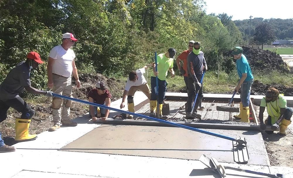 students pouring concrete