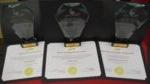 3 awards and 3 certificates on table