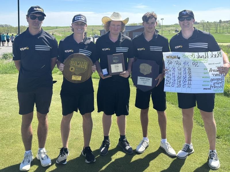 5 golfers standing on golf course with awards